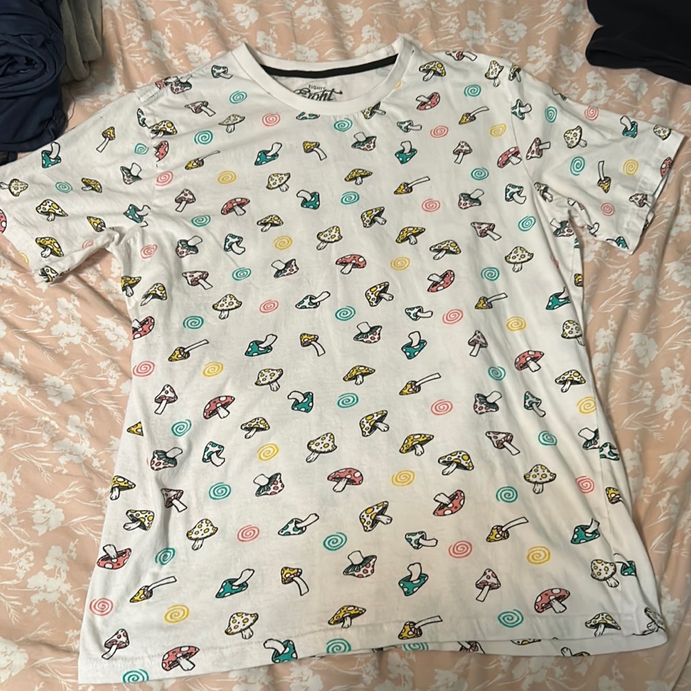 White T shirt, with small colorful mushrooms scattered around